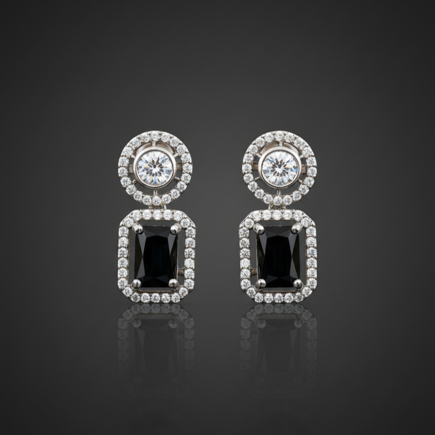 Elegant rhodium plated dangle earrings featuring a round halo stud and a large, emerald-cut black gemstone surrounded by a halo of brilliant American Diamonds (AD). Perfect for parties and formal events.