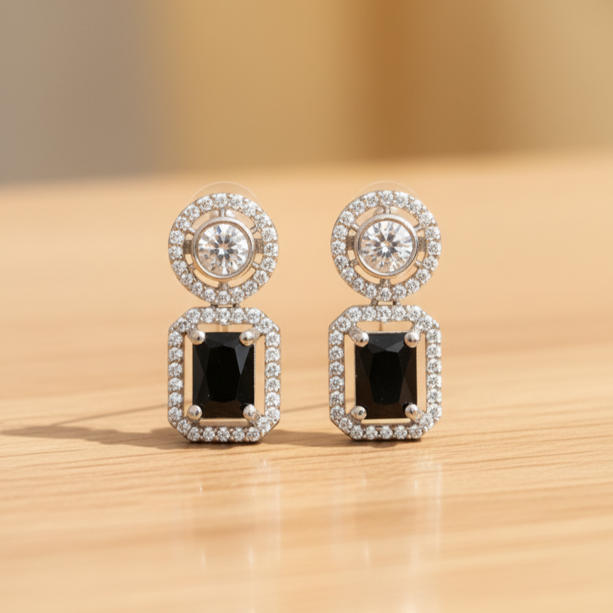 Elegant rhodium plated dangle earrings featuring a round halo stud and a large, emerald-cut black gemstone surrounded by a halo of brilliant American Diamonds (AD). Perfect for parties and formal events.