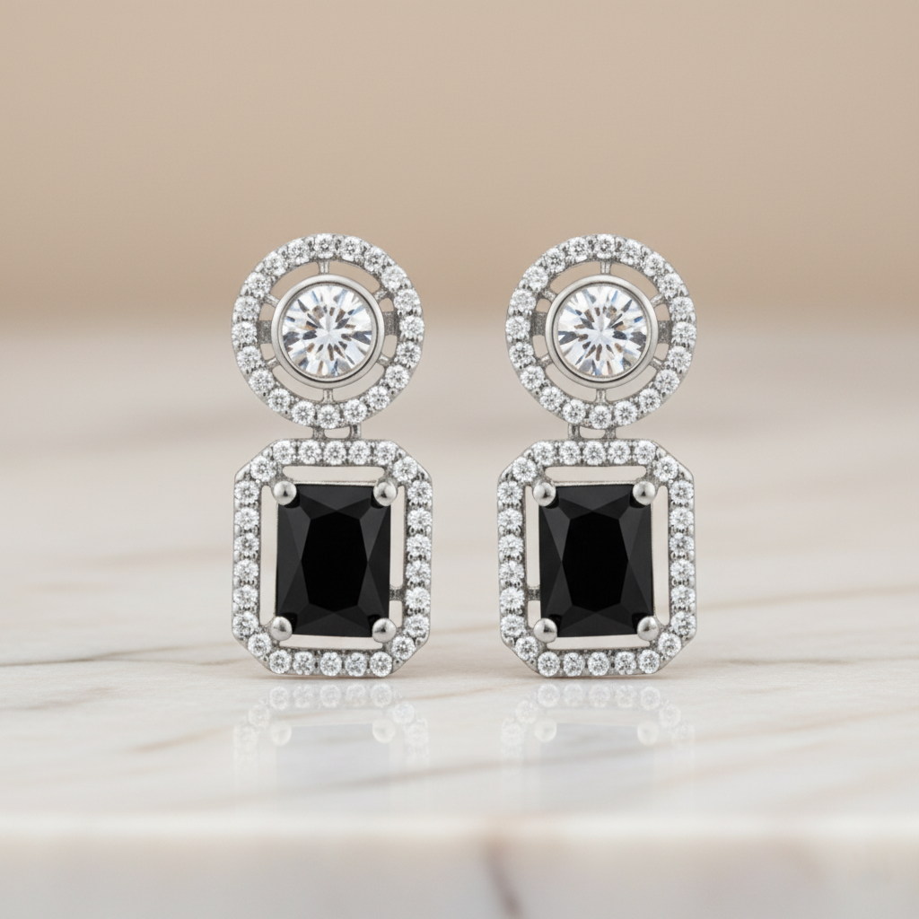 Elegant rhodium plated dangle earrings featuring a round halo stud and a large, emerald-cut black gemstone surrounded by a halo of brilliant American Diamonds (AD). Perfect for parties and formal events.