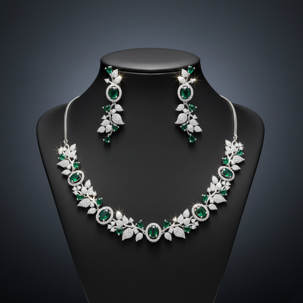 Elegant American Diamond necklace set with a sparkling marquise leaf and oval gemstone vine design. Available in white, green, blue, red, pink, and mint. Includes matching chandelier earrings for weddings and formal events.