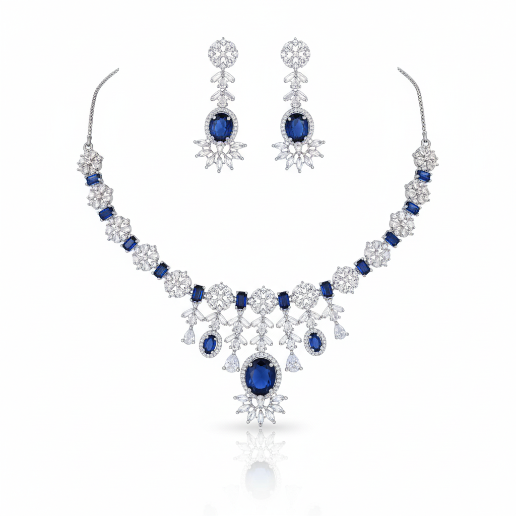 Grand bridal American Diamond (AD) chandelier necklace set with mixed-cut gemstones and a cascading pendant. Available in red, green, blue, pink, and white. Includes matching chandelier earrings for weddings. Grand Bridal Necklace Set, Wedding Jewellery Set, Chandelier Necklace, Statement Necklace, AD Necklace Set, American Diamond Jewellery, Party Wear Set, Reception Jewellery, Rhodium Plated, High Quality Imitation Jewellery, Luxury Artificial Jewellery, Designer Necklace Set, Chandelier Earrings