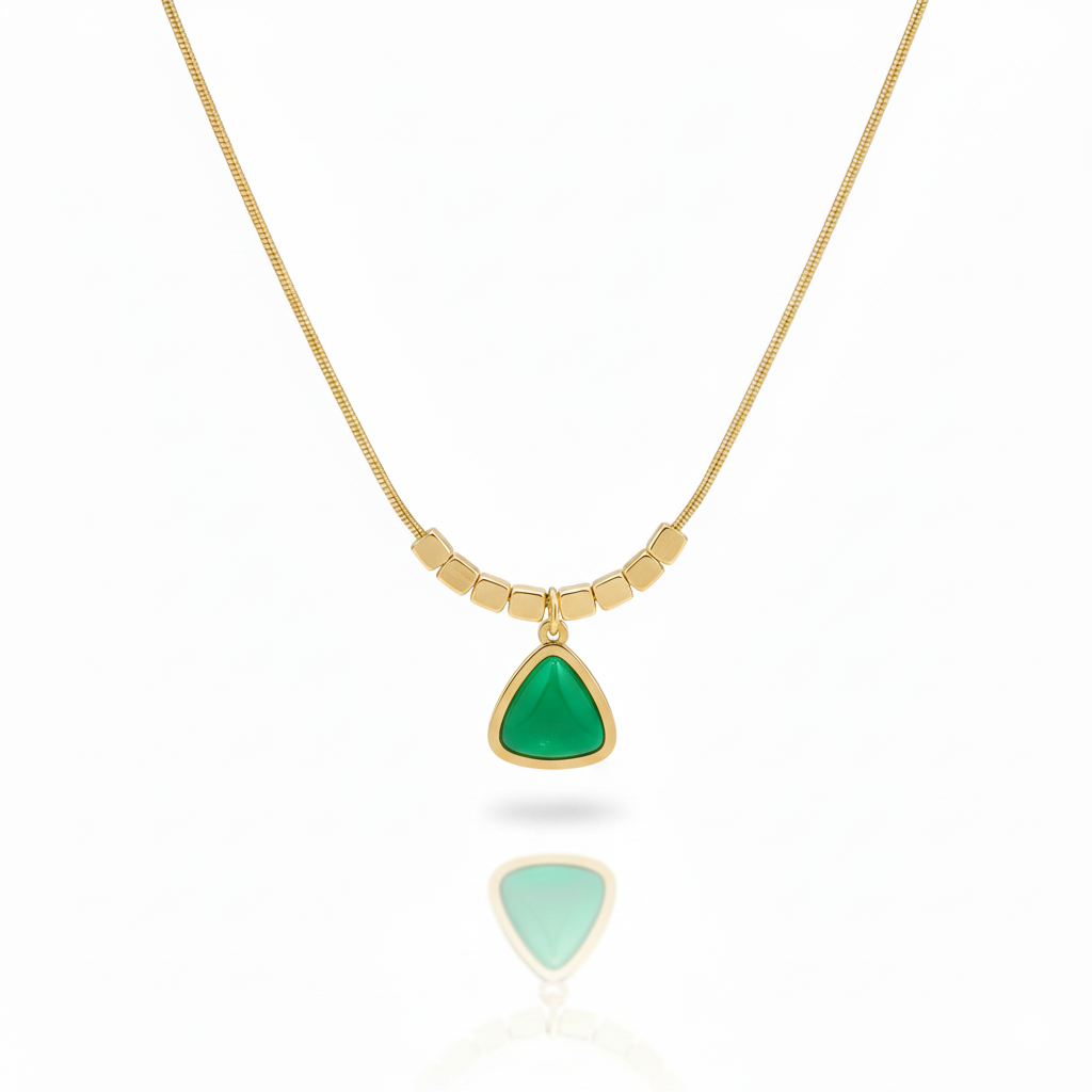 Minimalist gold plated snake chain necklace featuring a smooth triangular gemstone pendant and decorative square beads. Available in Green, Pink, and White. Modern daily wear jewellery for women. Minimalist Necklace, Gold Plated Necklace, Geometric Jewellery, Triangle Pendant, Snake Chain Necklace, Daily Wear Jewellery, Office Wear Necklace, Stone Pendant, Modern Necklace, Vrumaira, Surat Jewellery, Green Stone Necklace, Pink Stone Necklace, White Stone Necklace, Rose Quartz Look, Jade Look, Opal Look