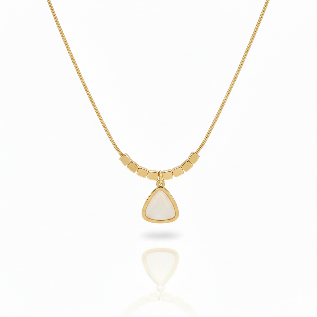 Minimalist gold plated snake chain necklace featuring a smooth triangular gemstone pendant and decorative square beads. Available in Green, Pink, and White. Modern daily wear jewellery for women. Minimalist Necklace, Gold Plated Necklace, Geometric Jewellery, Triangle Pendant, Snake Chain Necklace, Daily Wear Jewellery, Office Wear Necklace, Stone Pendant, Modern Necklace, Vrumaira, Surat Jewellery, Green Stone Necklace, Pink Stone Necklace, White Stone Necklace, Rose Quartz Look, Jade Look, Opal Look