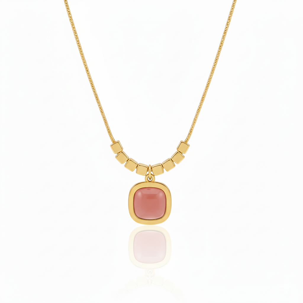 Minimalist gold plated snake chain necklace featuring a smooth square cushion-cut gemstone pendant and decorative cube beads. Available in Green, Peach, and Pink. Modern daily wear jewellery for women. Minimalist Necklace, Gold Plated Necklace, Square Pendant, Cushion Cut Necklace, Snake Chain, Cube Beads, Daily Wear Jewellery, Office Wear Necklace, Stone Pendant, Modern Necklace, Vrumaira, Surat Jewellery, Green Stone Necklace, Pink Stone Necklace, Peach Stone Necklace, Rose Quartz Look, Emerald Look
